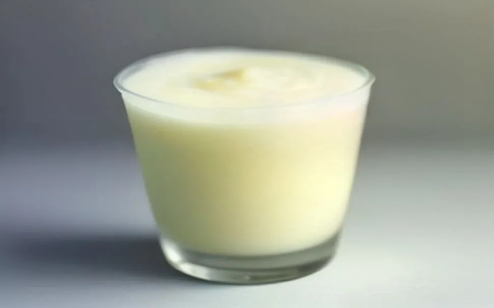 A tall cup of pale yellow frozen pineapple slush topped with a thick layer of cold foam — an illustration of the Pirate's Frozen Pineapple Float